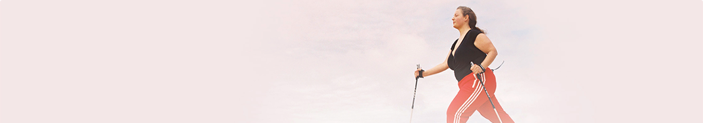 woman walking with trekking poles